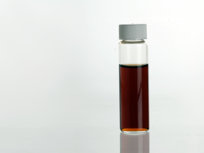 Vanilla (Vanilla planifolia) Extract in clear glass vial.