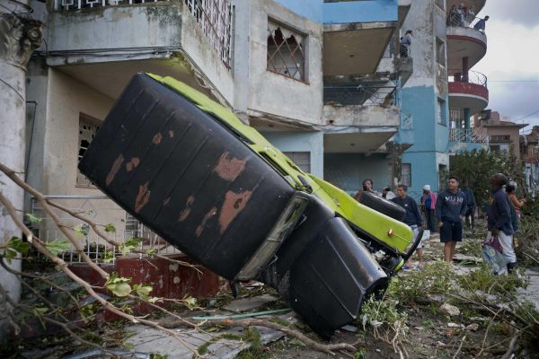truck is toppled against house