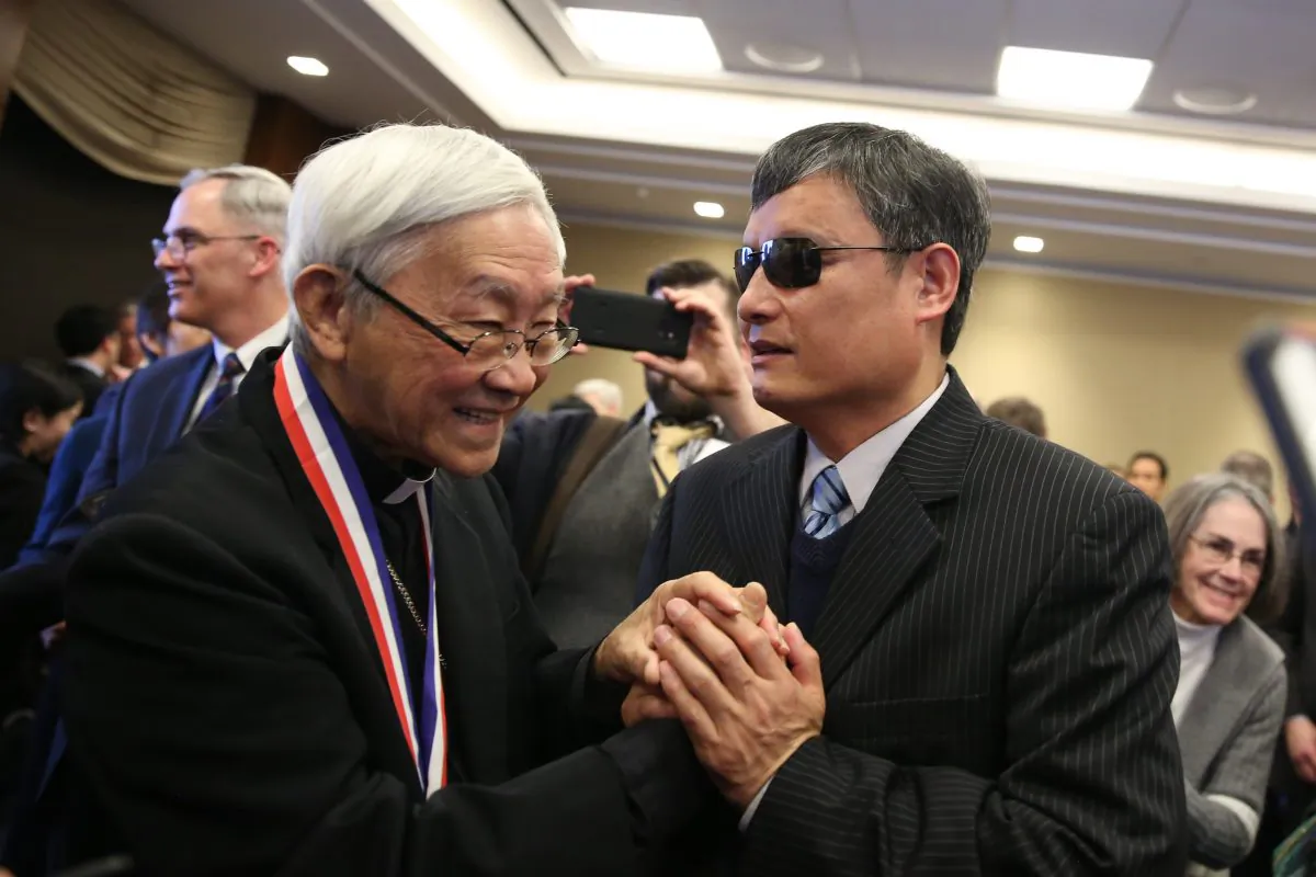 Chen Guangcheng, blind Chinese civil rights activist and lawyer (R), greets Cardinal Joseph Zen, recipient of the Truman-Reagan Medal of Freedom during a ceremony at the Rayburn House Office Building on Capitol Hill in Washington, D.C., on Jan. 28, 2019. (Samira Bouaou/The Epoch Times)