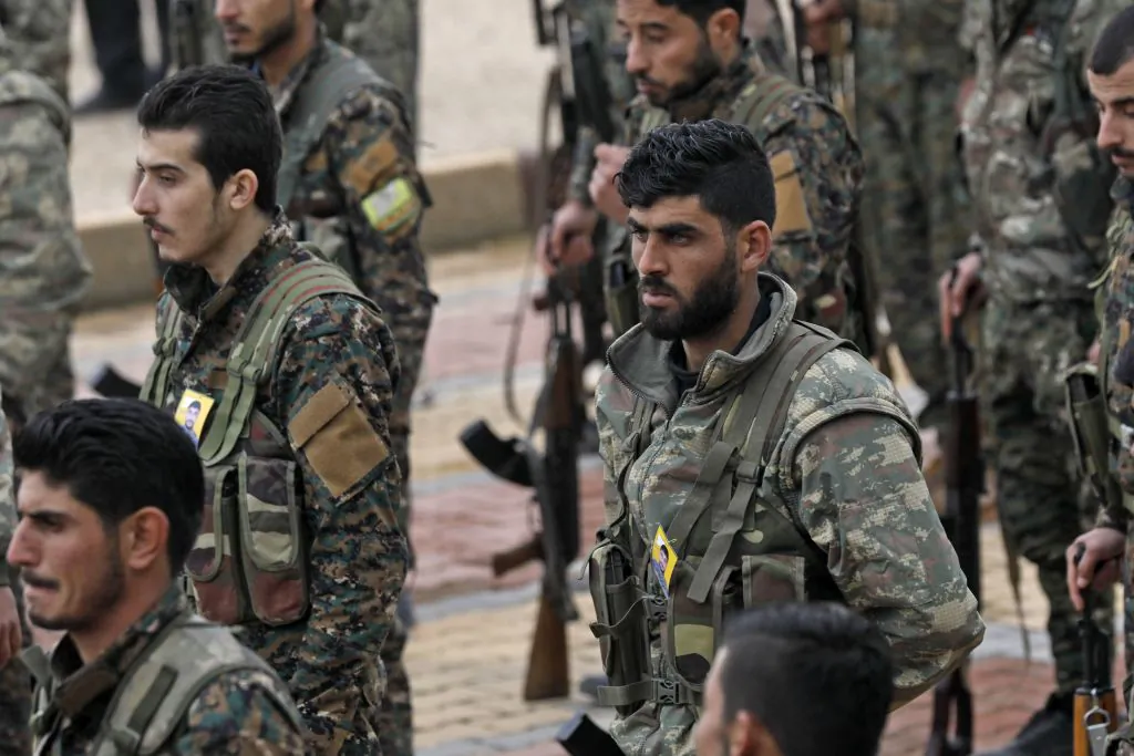 Fighters from the Syrian Democratic Forces (SDF) attend the funeral of a fellow fighter, who was killed while fighting against ISIS in northeastern Syrian Kurdish-majority city of Qamishli, on Jan. 18, 2019. (Delil Souleiman/AFP/Getty Images)
