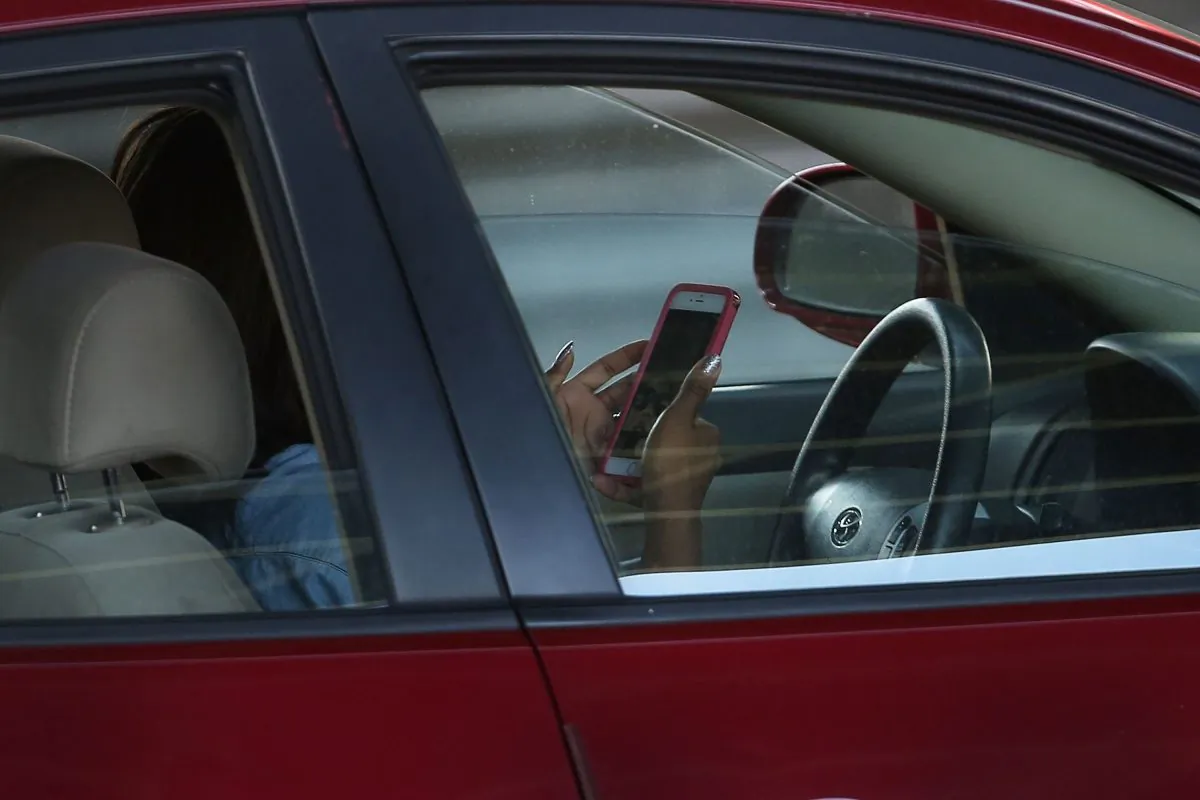 A driver uses a phone while behind the wheel of a car in New York City on April 30, 2016. (Photo by Spencer Platt/Getty Images)