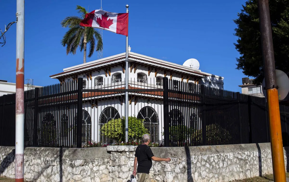 In this April 17, 2018 file photo, a man walks beside Canada's embassy in Havana, Cuba. Canada has confirmed 14 cases of mysterious health problems since early 2017. (AP Photo/Desmond Boylan, File)