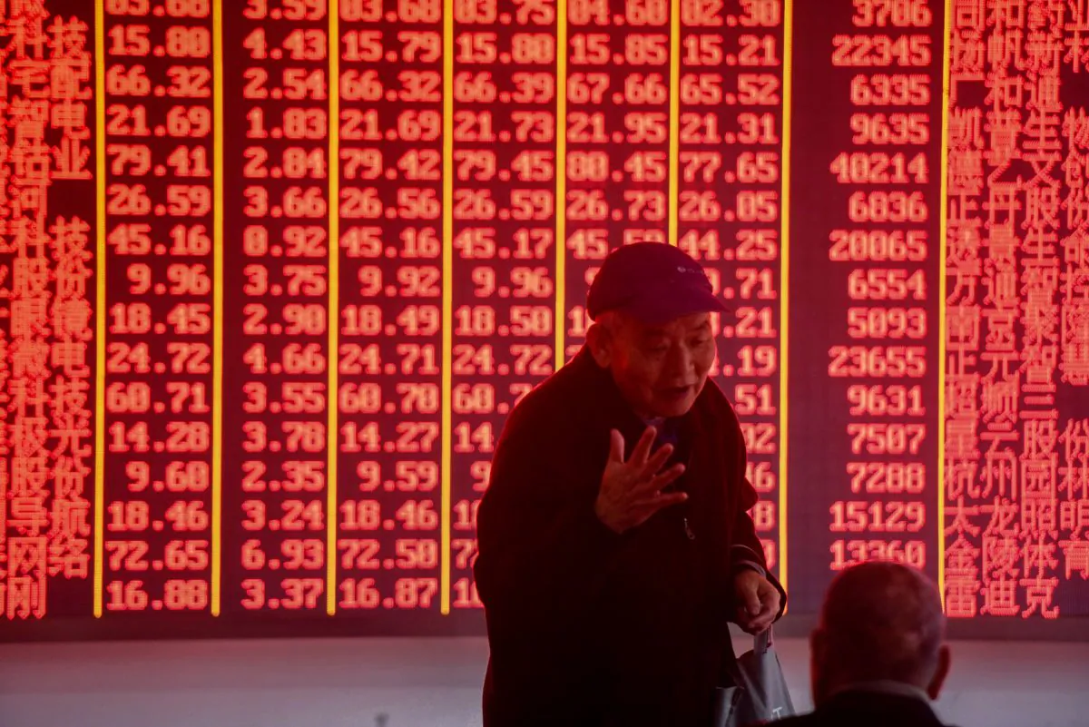 Investors talk in front of an electronic board showing stock information at a securities company in Hangzhou City, Zhejiang Province, China, on December 3, 2018. Standard & Poor’s wholly-owned Chinese subsidiary has been approved to offer credit rating services in China. (STR/AFP/Getty Images)