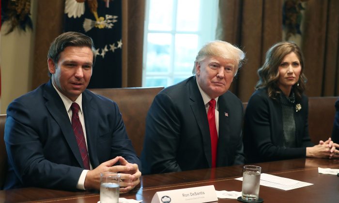 South Dakota Governor-elect Kristi Noem (R) sits sits next to U.S. President Donald Trump and   Florida Governor-elect Ron DeSantis (L) at the White House on Dec. 13, 2018 in Washington, DC.  (Mark Wilson/Getty Images)