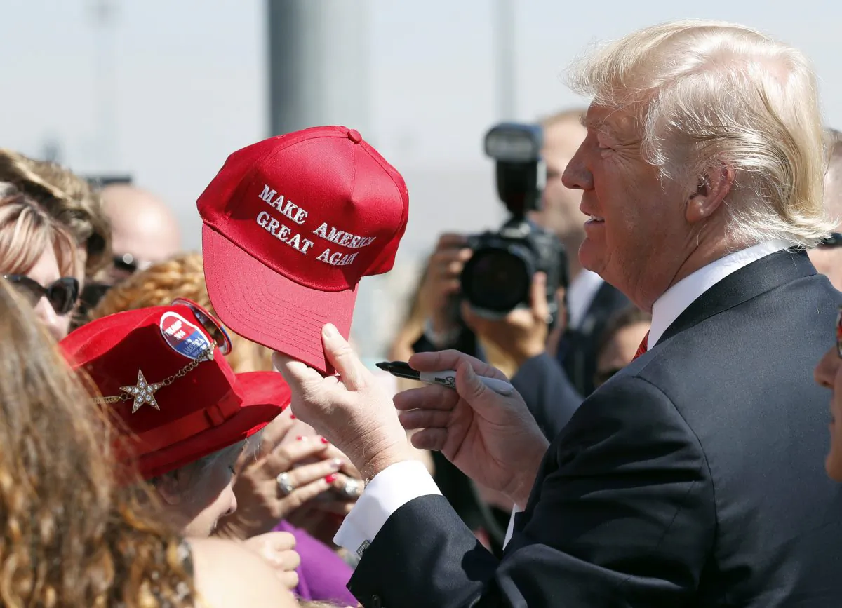 In this Aug. 23, 2017 file photo, President Donald Trump hands a signed "Make America Great Again," hat back to a supporter in Reno, Nev. An award-winning cookbook author and California restaurant owner says anyone wearing a red "Make America Great Again" baseball cap will be refused service at his restaurant. J. Kenji Lopez-Alt is a chef-partner of the Wursthall restaurant in San Mateo and says in a tweet Sunday, Jan. 27, 2019, that he views the hats as symbols of intolerance and hate. (AP Photo/Alex Brandon, File)