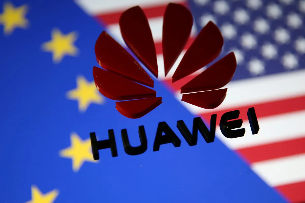 A 3D printed Huawei logo is placed on glass above a display of EU and U.S. flags in this illustration taken on Jan. 29, 2019. (Dado Ruvic/Reuters)