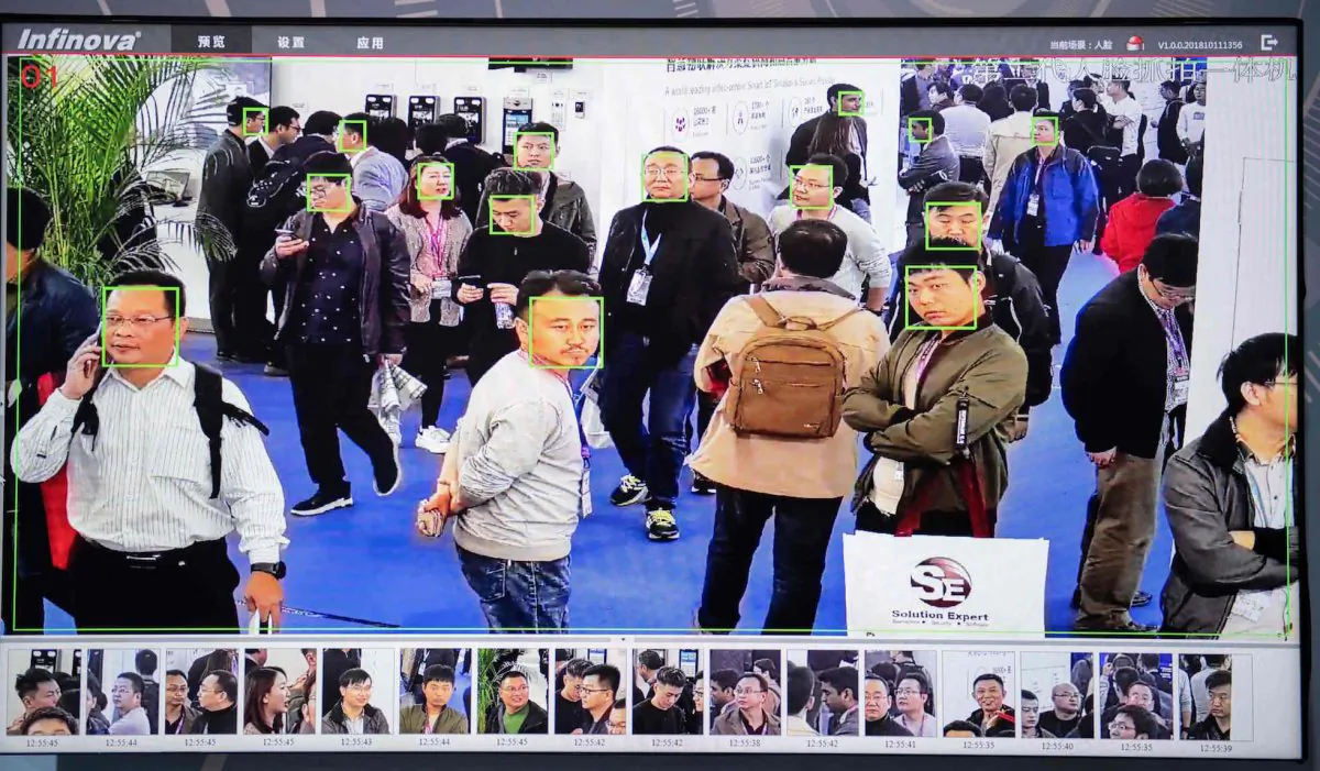 A screen shows visitors being filmed by AI security cameras with facial recognition technology at the 14th China International Exhibition on Public Safety and Security at the China International Exhibition Center in Beijing on Oct. 24, 2018. (Nicolas Asfouri/AFP/Getty Images)
