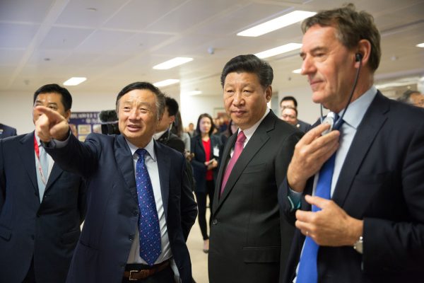 Chinese leader Xi Jinping (C) is shown around the offices of Huawei by its President Ren Zhengfei (2nd L) in London during Xi's state visit on Oct. 21, 2015. (Matthew Lloyd/AFP/Getty Images