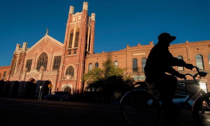 A man rides his bicycle past the Sagrado Corazon Church in the El Segundo Barrio in El Paso, Texas, on Nov. 28, 2018. (PAUL RATJE/AFP/Getty Images)