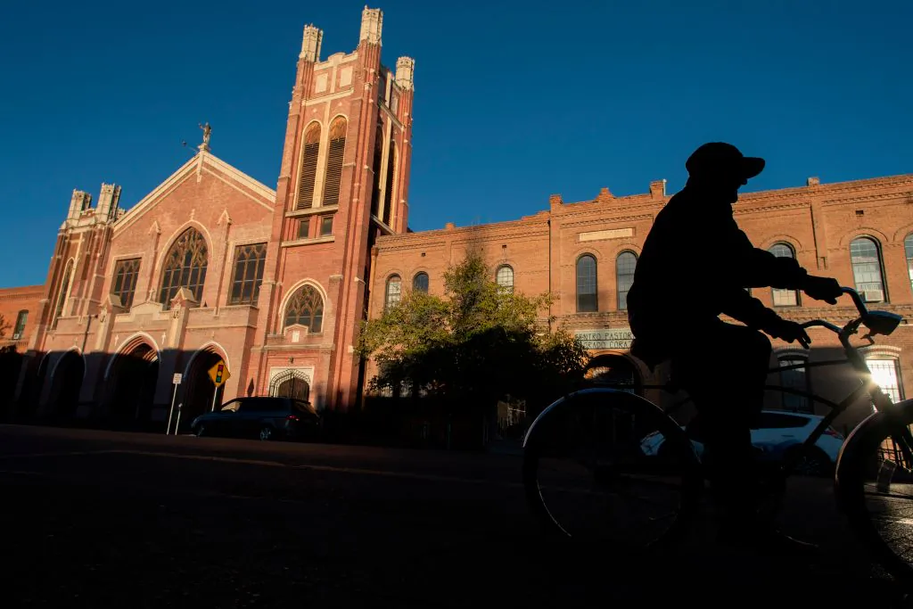 A man rides his bicycle past the Sagrado Corazon Church in the El Segundo Barrio in El Paso, Texas, on Nov. 28, 2018. (PAUL RATJE/AFP/Getty Images)