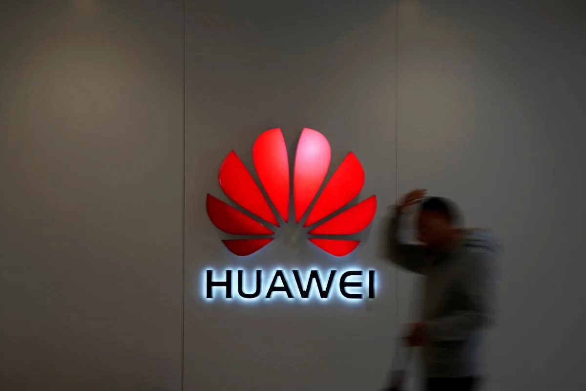 A man walks by a Huawei logo at a shopping mall in Shanghai, China on Dec. 6, 2018. (Aly Song/Reuters)
