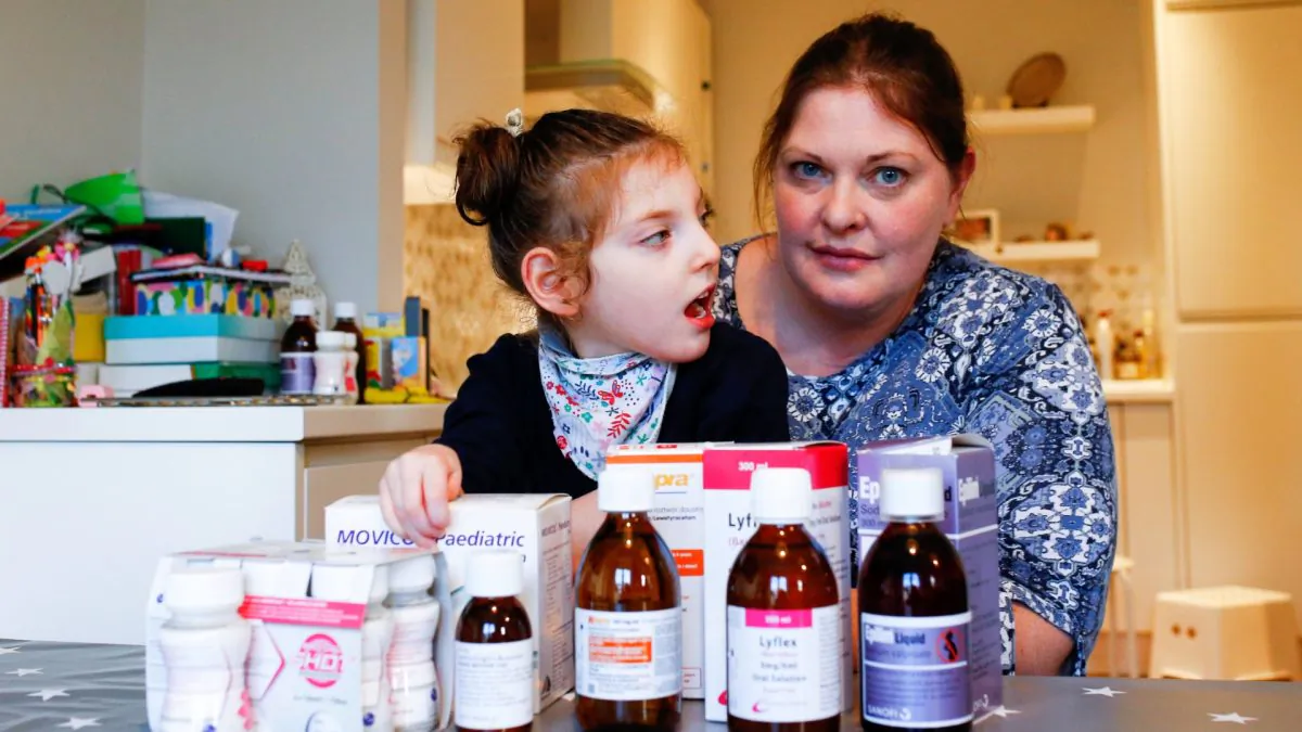 Jo Elgarf with her daughter Nora and the child's prescription medicine at their home in London on Jan. 30, 2019. (Henry Nicholls/Reuters)
