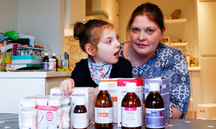 Jo Elgarf with her daughter Nora and the child's prescription medicine at their home in London on Jan. 30, 2019. (Henry Nicholls/Reuters)