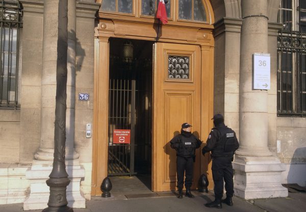 Police officers stand guard in front of the 36 Quai des Orfevres police headquarters 