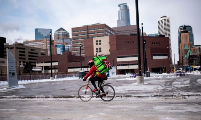 A bicyclist braves the cold while riding through downtown in Minneapolis, Minnesota on Jan. 29, 2019. (Stephen Maturen/AFP/Getty Images)