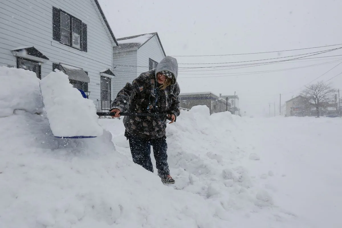 A woman shovels her neighbor's driveway during a snowstorm in Manitowoc, Wis. on Jan. 28, 2019. Three people are believed to have died from the polar vortex in Milwaukee County, including a 38-year-old woman who froze to death on Jan. 30, 2019. (Joshua Clark/The Post-Crescent via AP)