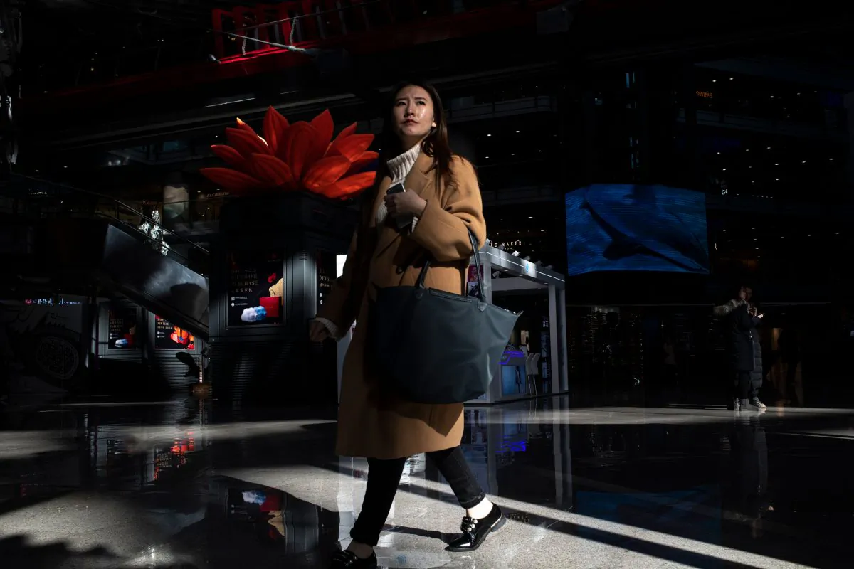 Customers walk in a Beijing shopping mall on Jan. 21, 2019. (Fred Dufour/AFP/Getty Images)