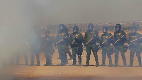 Officers in smoke tear gas