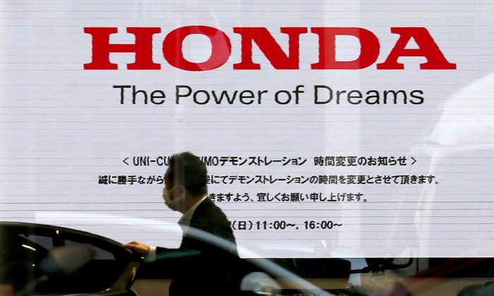 In this Jan. 11, 2016, file photo, the logo of Honda Motor Co. is seen on a Honda vehicle at the Japanese automaker's headquarters in Tokyo.  (Shuji Kajiyama/AP)