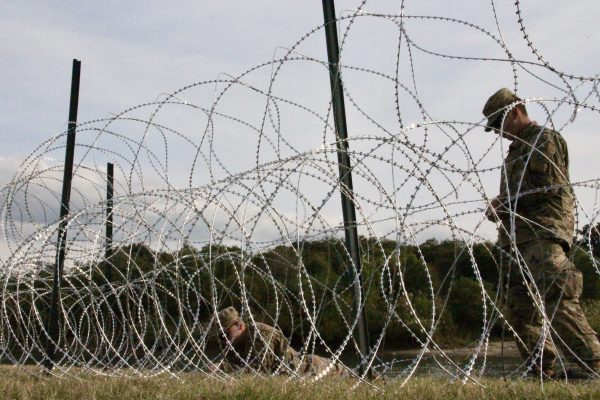 Soldiers install barbed wire