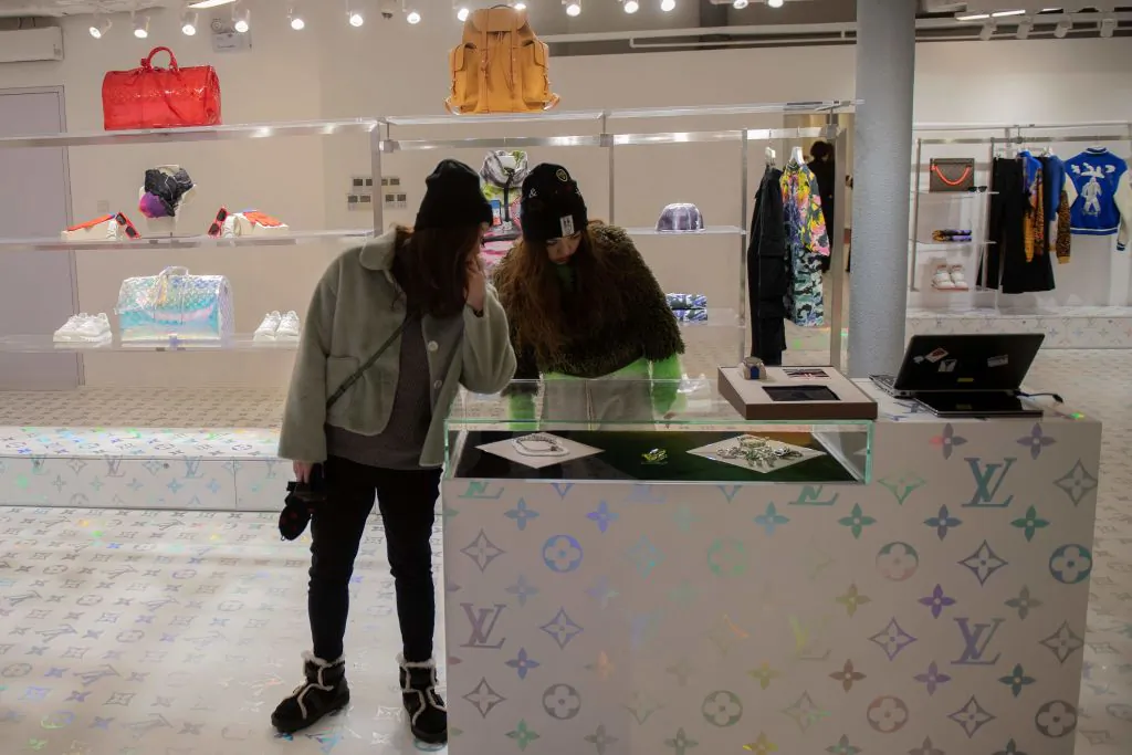 Customers shop inside a luxury shop in Beijing on Jan. 21, 2019. (Nicolas Asfouri/AFP/Getty Images)