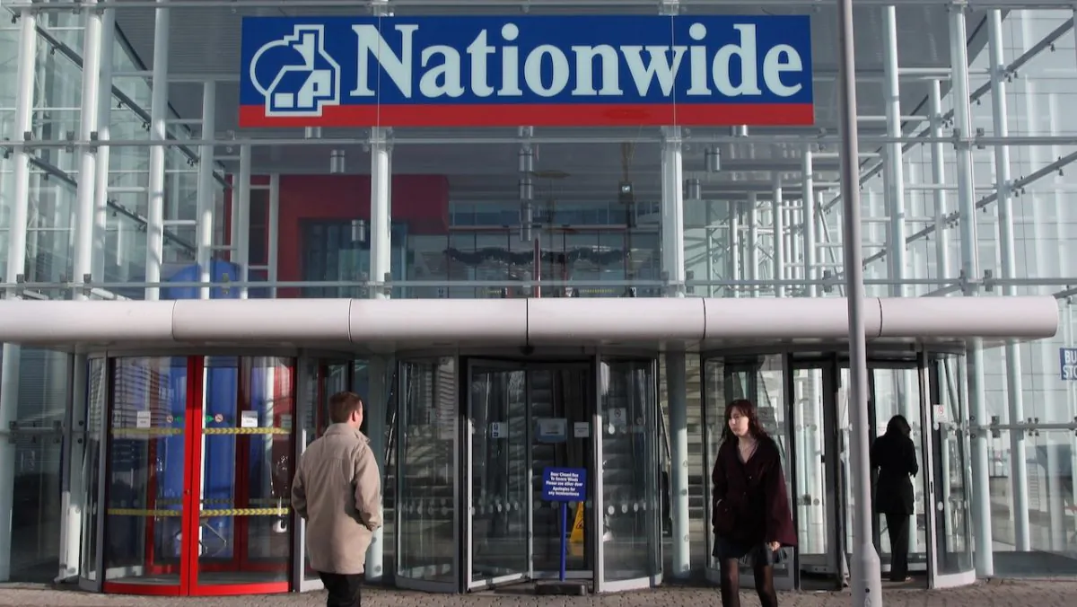 People walk into the main entrance of the Nationwide Building Society HQ in Swindon, England, on Jan. 2, 2009. (Matt Cardy/Getty Images)