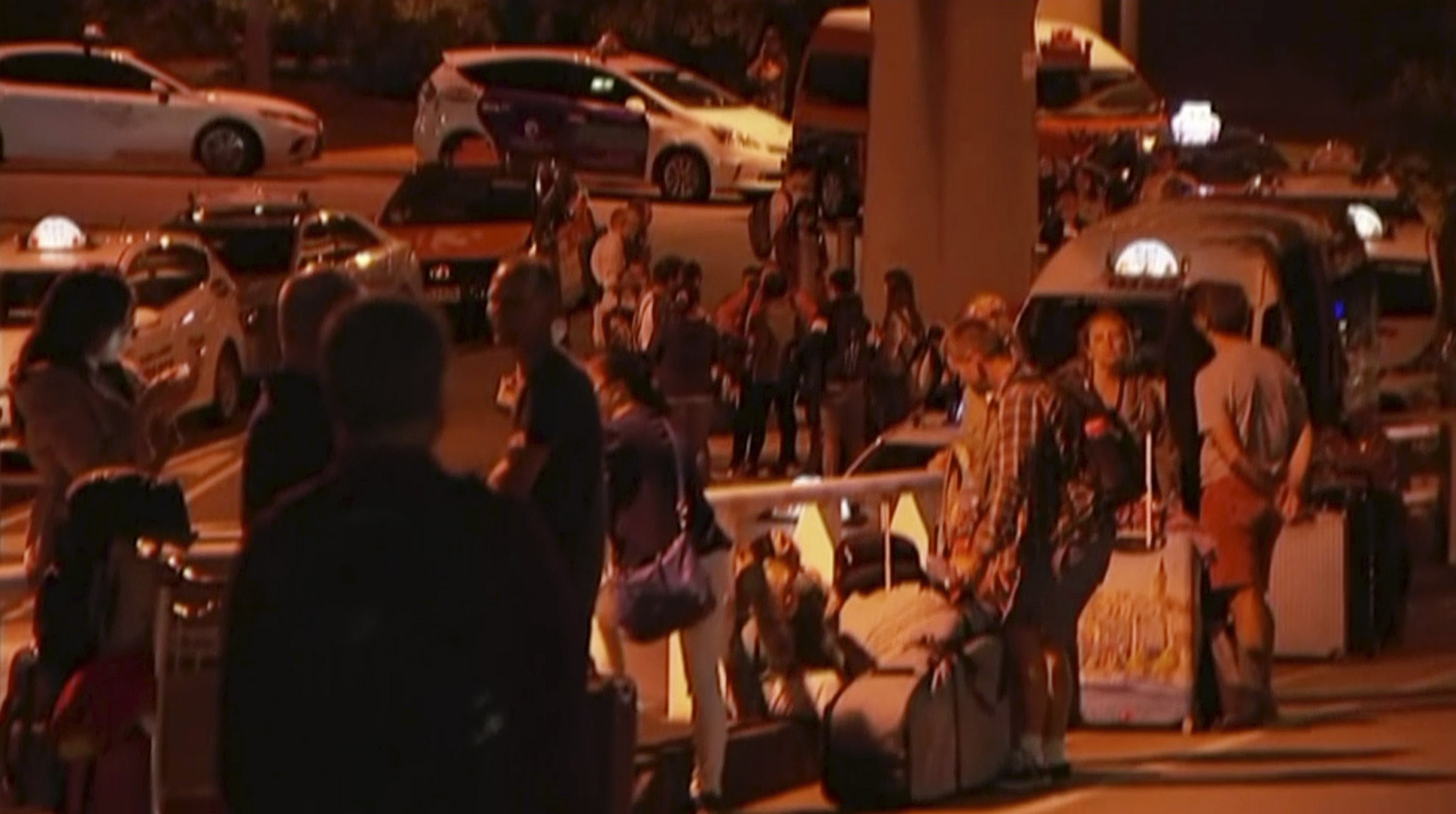 travelers stay outside Brisbane airport