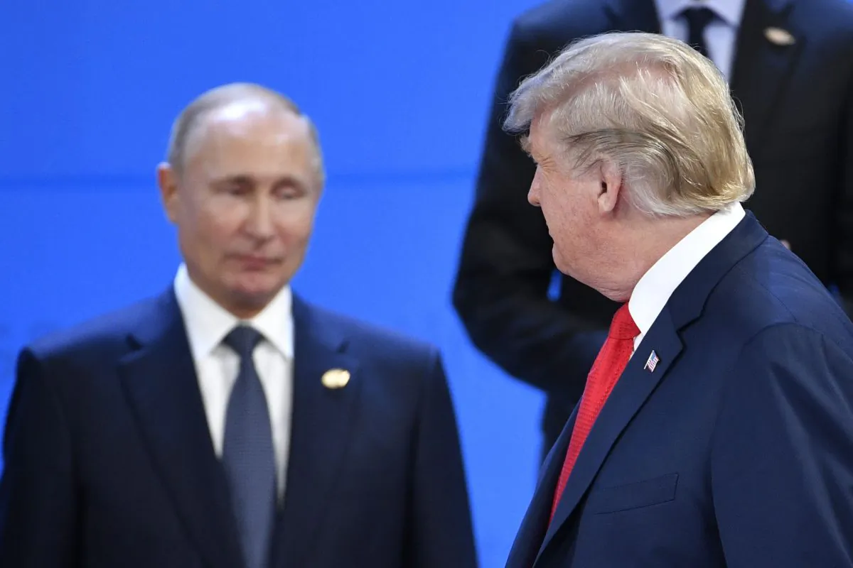 US President Donald Trump (R) looks at Russia's President Vladimir Putin as they take their places for a family photo, during the G20 Leaders' Summit in Buenos Aires, on November 30, 2018. - Global leaders gather in the Argentine capital for a two-day G20 summit beginning on Friday likely to be dominated by simmering international tensions over trade. (Photo by Alexander NEMENOV / AFP) (Photo credit should read ALEXANDER NEMENOV/AFP/Getty Images)
