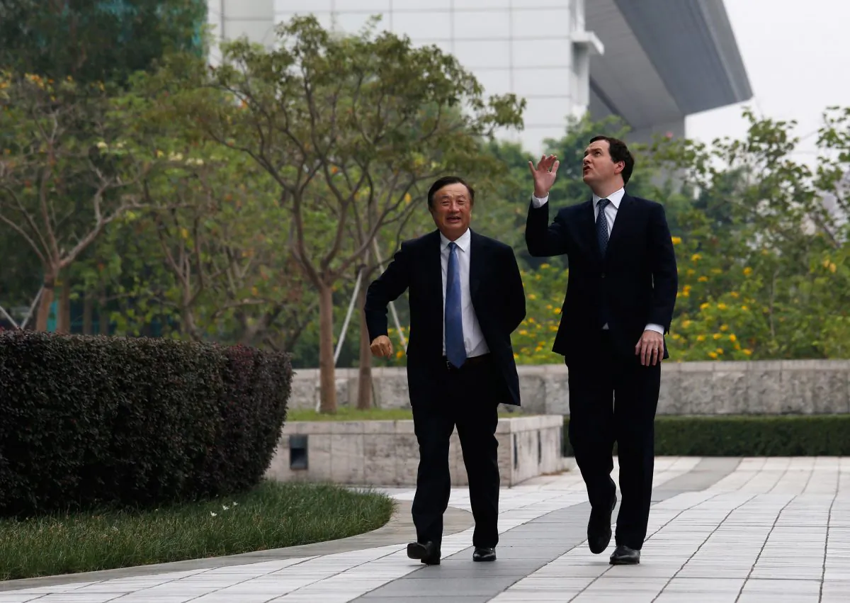 Huawei invites foreign officials to its headquarter as public relations methods. The photo was shot on on October 16, 2013 when British Chancellor George Osborne (L) visited Huawei headquarter and accompanied by Huawei CEO and founder Ren Zhengfei. (Bobby Yip - Pool/Getty Images)