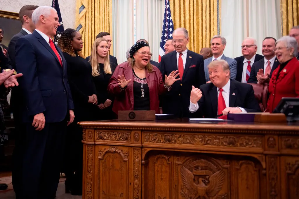 US President Donald Trump gestures as American conservative activist and author Alveda King (C), a niece of Martin Luther King Jr., speaks before Trump signs the First Step Act and the Juvenile Justice Reform Act at the White House in Washington, DC, on Dec. 21, 2018. (Jim Watson/AFP)