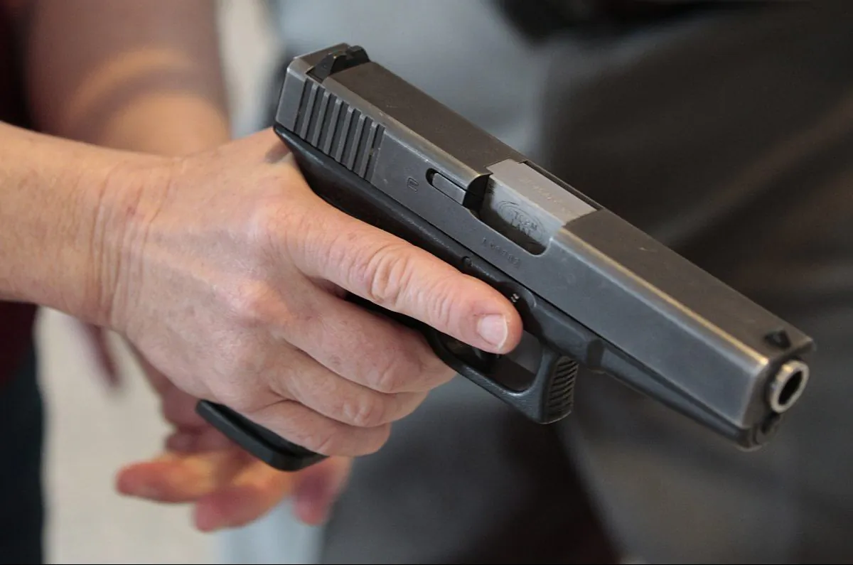 A person holds a gun in a file photo. (George Frey/Getty Images)