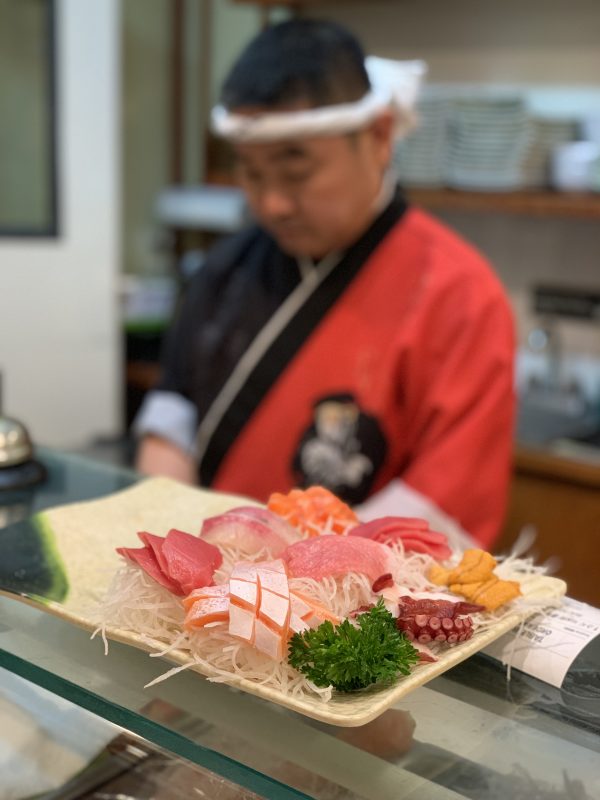 Sashimi platter on sushi counter from Golden Sushi