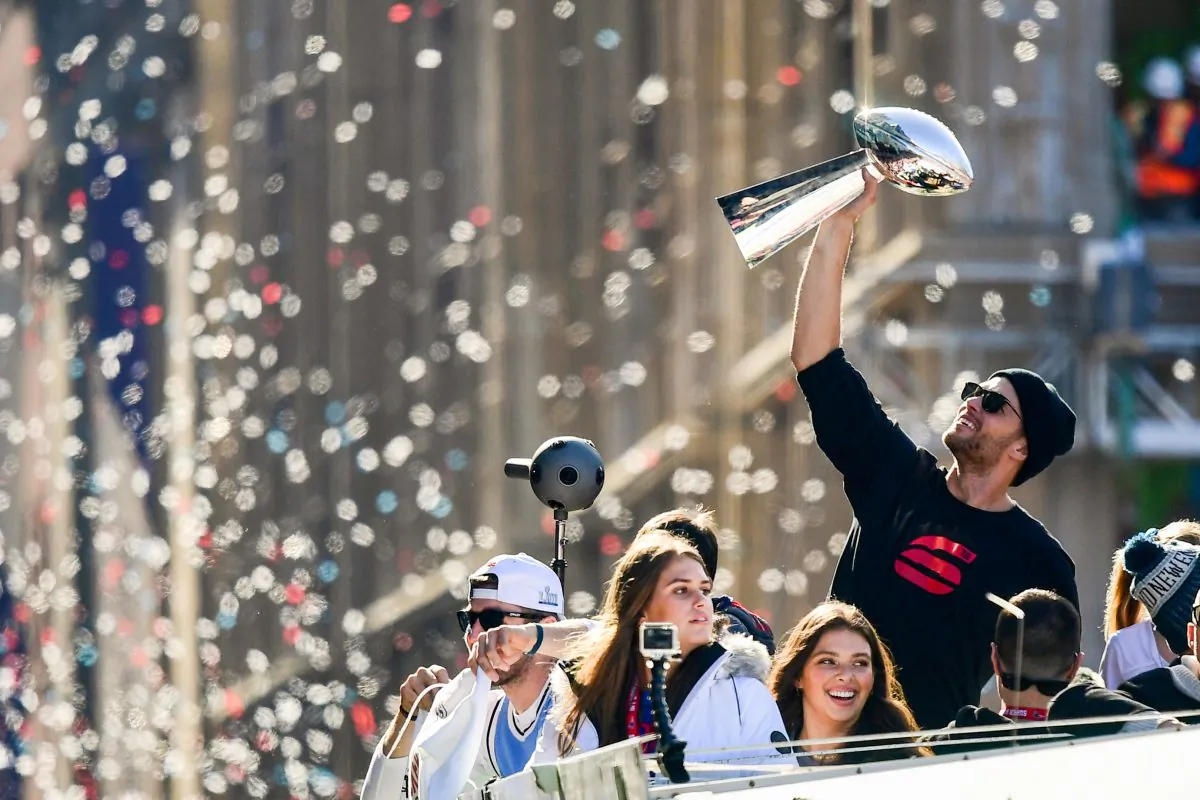 Tom Brady #12 of the New England Patriots reacts as he holds the Vince Lombardi trophy during the Super Bowl Victory Parade in Boston, Mass., on Feb. 5, 2019. (Billie Weiss/Getty Images)