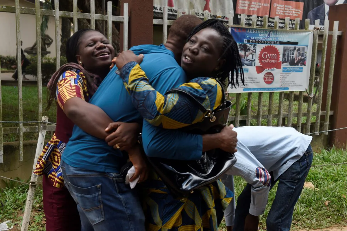 A returnee migrant (C) brought home from Libya is embraced by relatives in Benin, capital of Edo State in midwest Nigeria, on Dec. 7, 2017.  (Pius Utomi Ekpei/AFP/Getty Images)