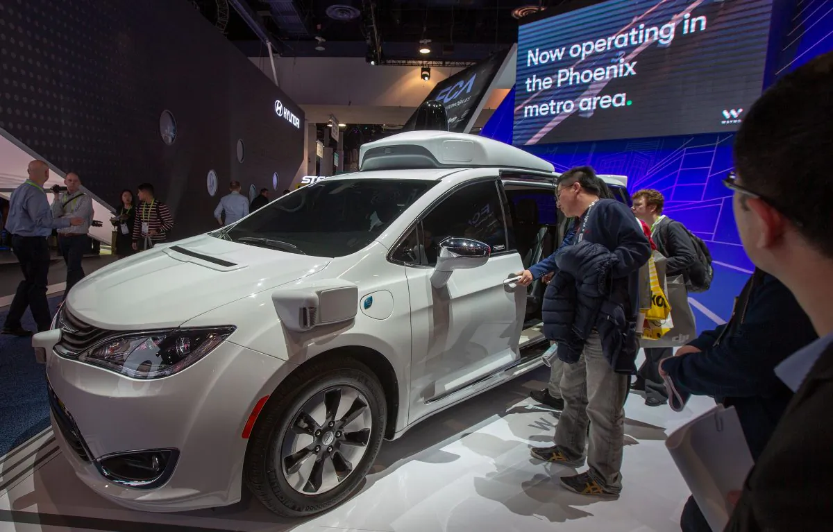 People look at a Waymo self-driving car during CES 2019 in Las Vegas on Jan. 9, 2019.
(DAVID MCNEW/AFP/Getty Images)