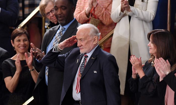 Former NASA astronaut Buzz Aldrin salutes as he is recognized by US President Donald Trump during the State of the Union address at the US Capitol on Feb. 5, 2019. (Saul Loeb/AFP/Getty Images)