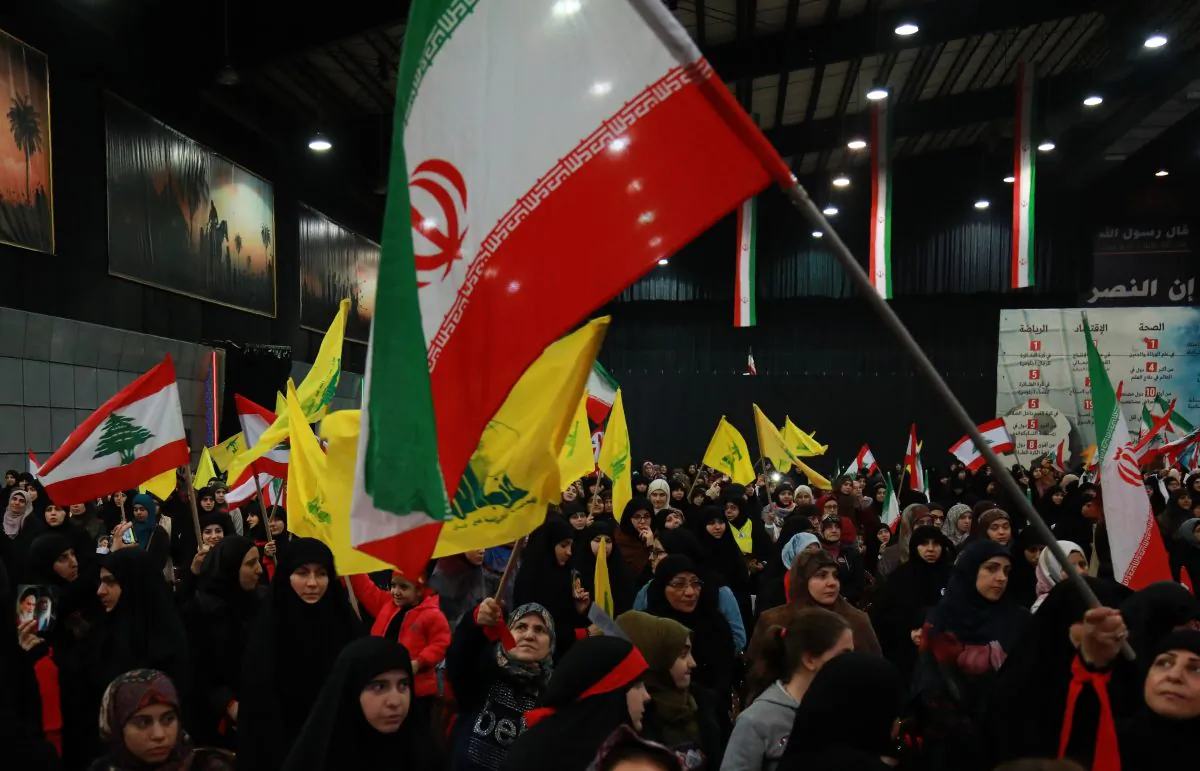 Supporters of Lebanon's Shiite movement Hezbollah wave national, Iranian as well as the movement's yellow flag during celebrations marking the 40th anniversary of the Iranian revolution in the capital Beirut's southern suburbs on February 6, 2019. ANWAR AMRO/AFP/Getty Images