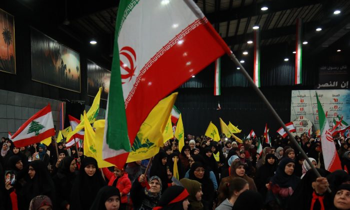 Supporters of Lebanon's Shiite movement Hezbollah wave national, Iranian as well as the movement's yellow flag during celebrations marking the 40th anniversary of the Iranian revolution in the capital Beirut's southern suburbs on February 6, 2019. ANWAR AMRO/AFP/Getty Images