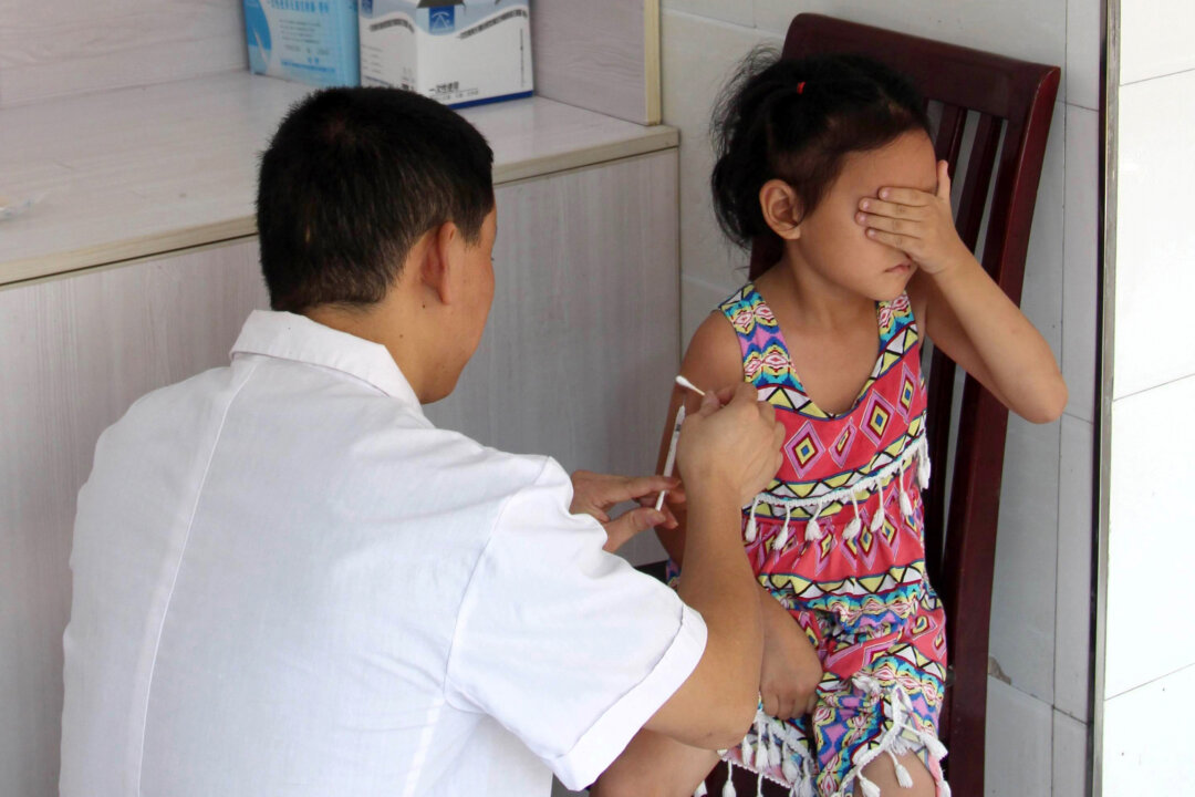 A child receives a vaccination shot at a hospital in Yunyang County in Chongqing City on Aug. 15, 2018. (STR/AFP/Getty Images)
