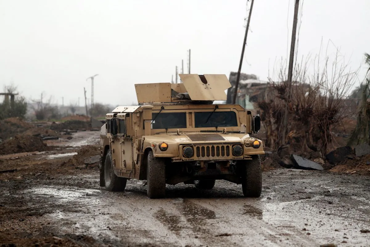 Syrian Democratic Forces (SDF) vehicles make their way on a dirt road on Jan. 28, 2019, in the town of Sousa, in Syria's eastern province of Deir Ezzor. (DELIL SOULEIMAN/AFP/Getty Images)