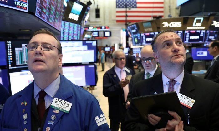 Traders work on the floor of the New York Stock Exchange (NYSE) in N.Y. on Feb. 4, 2019. (Brendan McDermid/Reuters)
