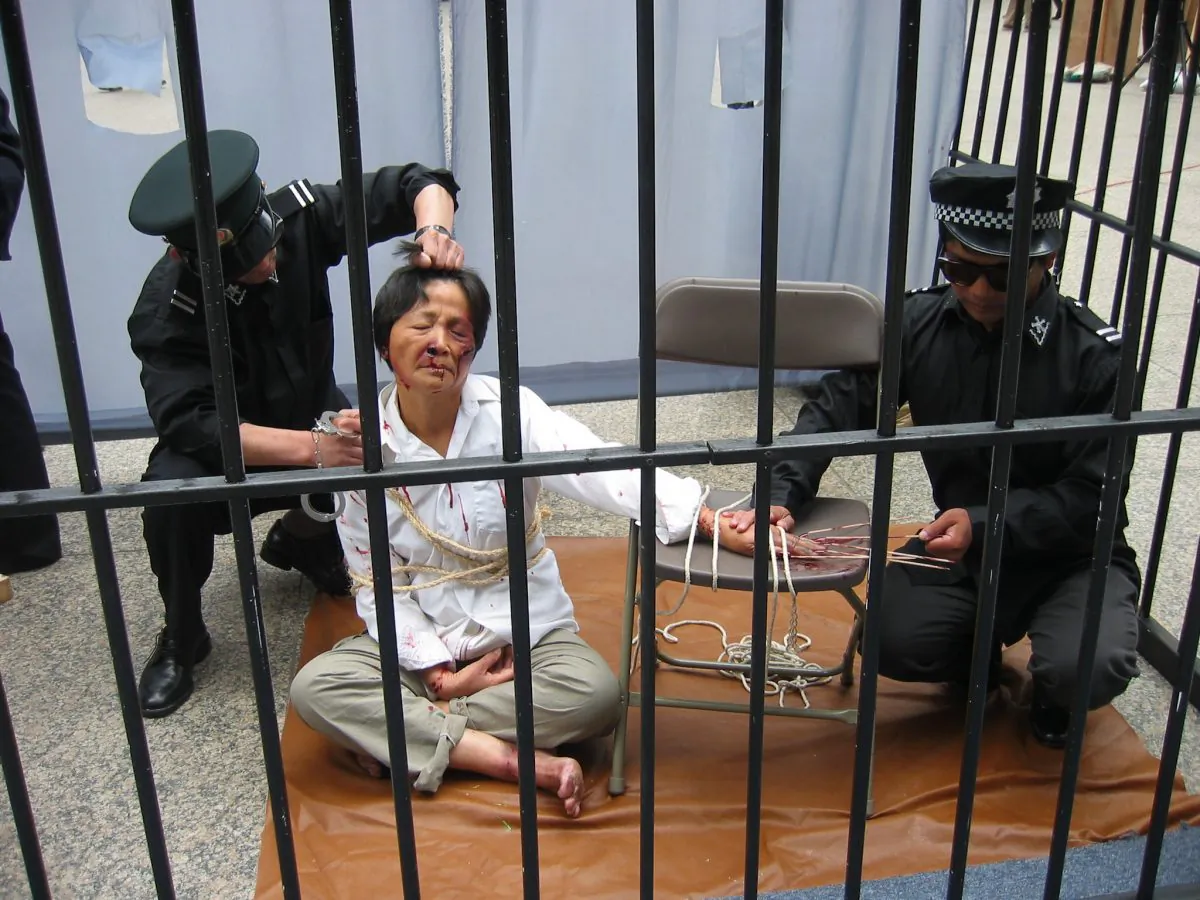 A reenactment of a Falun Gong practitioner being tortured by police in a detention center. (Minghui.tv)