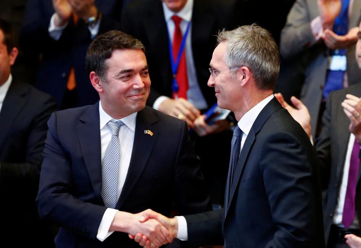 Macedonian Foreign Minister Nikola Dimitrov shakes hands with NATO Secretary General Jens Stoltenberg in Brussels on Feb. 6, 2019. (Francois Lenoir/Reuters)