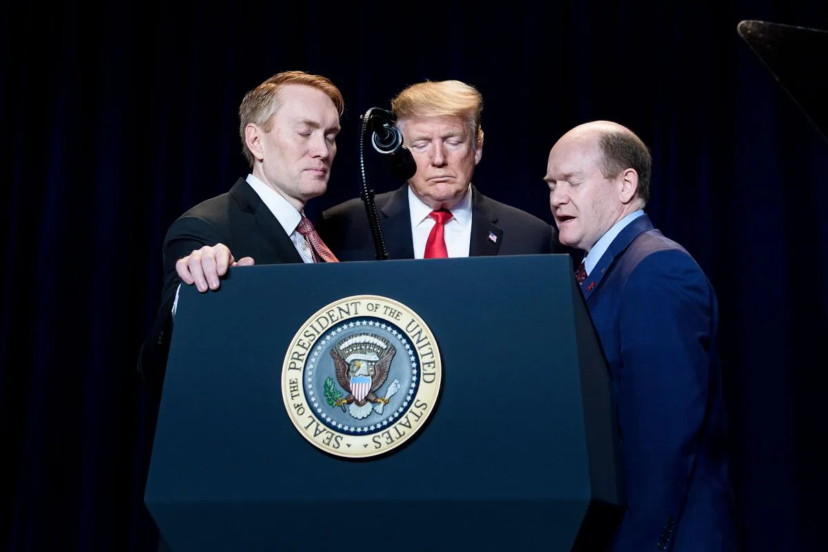 President Donald Trump (C), Senator James Lankford (R-OK) (L), and Senator Christopher Coons (D-DE), during the National Prayer Breakfast in Washington on Feb. 7, 2019. (Brendan Smialowski/AFP/Getty Images)