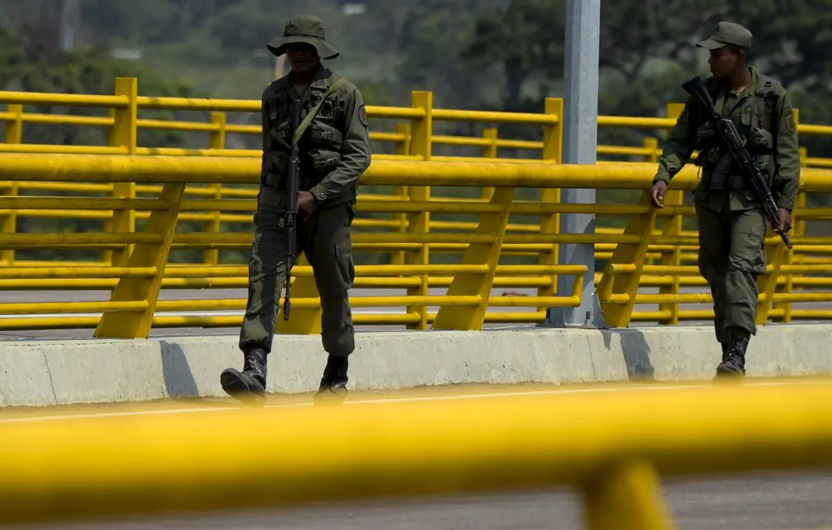 Venezuelan military forces stand guard as they block with containers the Tienditas Bridge, which links Tachira, Venezuela, and Cucuta, Colombia, on Feb. 6, 2019. (RAUL ARBOLEDA/AFP/Getty Images)
