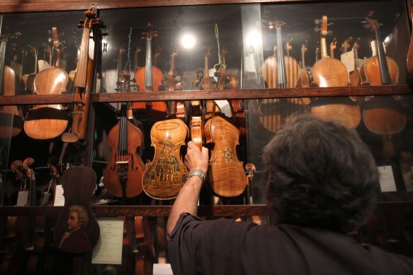 Israeli violin maker Amnon Weinstein shows his violin collection