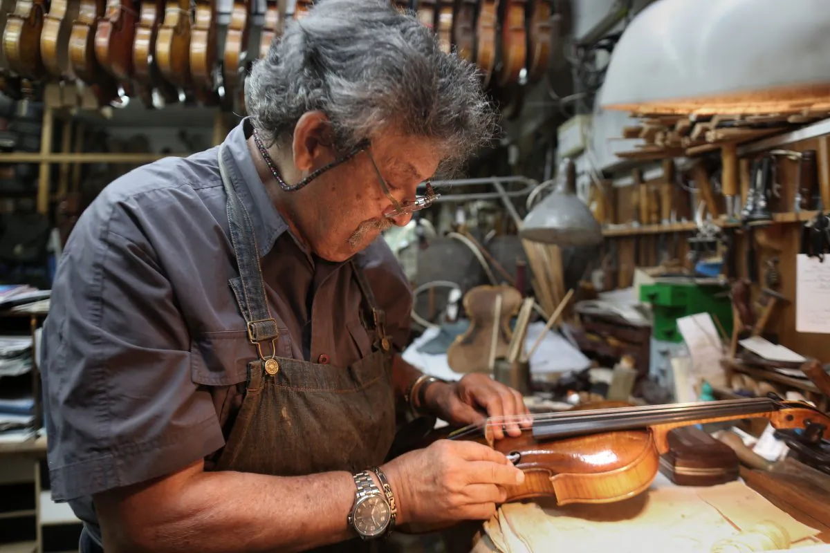 Israeli violin maker Amnon Weinstein restores a violin which he named the "Auschwitz Violin" since it belonged to a Jewish man imprisoned at the Auschwitz concentration camp during the Second World war at his workshop in Tel Aviv on July 15, 2016.
(Menahem Kahana/AFP/Getty Images)