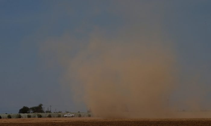 Dust over an empty field in Madera, Calif. on April 24, 2015. (Photo by Justin Sullivan/Getty Images)