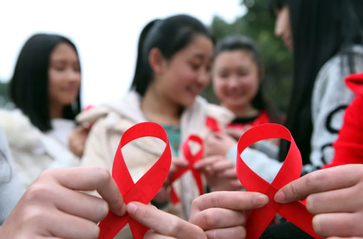Volunteers take part in an event to mark World Aids Day in Chongqing, China. (STR/AFP/Getty Images)