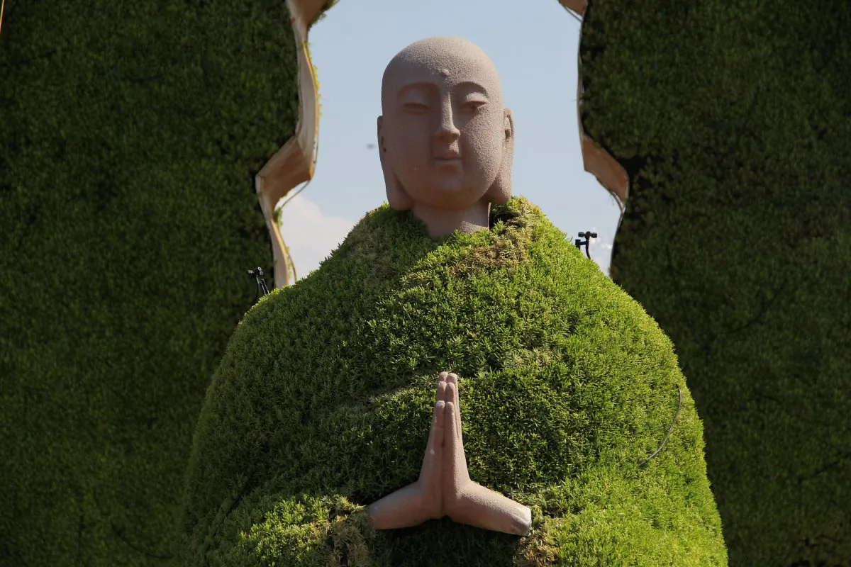 A sculpture of Monk Tang (also known as Tang Xuanzang in the Chinese novel "Journey to the West") wearing a "green coat" made up of green plants at Dayanta in Xi'an, Shaanxi Province of China on July 15, 2014. (VCG via Getty Images)